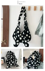 Detail view of plush polka dot tote bag with a large bow and knotted handle design