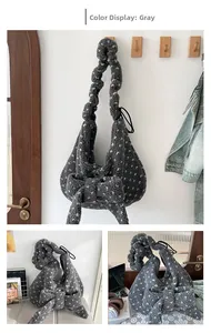 Detail of dark grey plush tote bag featuring a 3D white bow and curly fleece texture