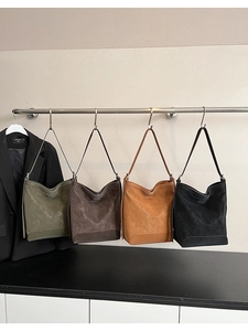 Row of minimalist large capacity hobo bags in green, brown, tan and black synthetic leather