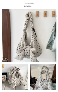 Detail of plush off-white tote bag with blue floral patterns and large bow decoration