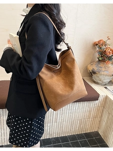 Deep brown suede Hobo shoulder bag shown with an elegant urban commute outfit