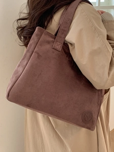 Elegant large capacity dark purple suede tote bag worn over a beige trench coat