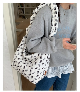 Detail view of large capacity quilted tote bag with black and grey polka dots