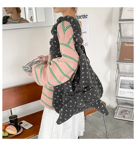 Detail view of large grey teddy fleece tote bag with a decorative plush oversized bow