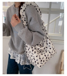 Detailed view of the textured polka dot tote bag styled with a casual Korean fashion outfit