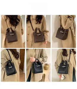 Detailed views of the textured leather bucket bag with metal buckle in brown and black