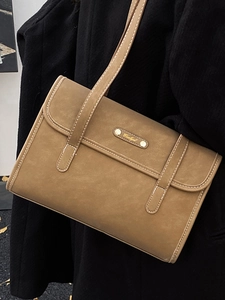 Brown vintage minimalist shoulder bag with matte leather finish and golden metal plate