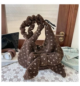 Detail of plush brown tote bag with large bow and starry pattern on white lace