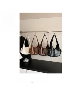 Detail view of smooth leather underarm bags in four colors with side pocket feature