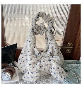 Close-up of plush fleece texture with blue floral patterns and stylish bow detail