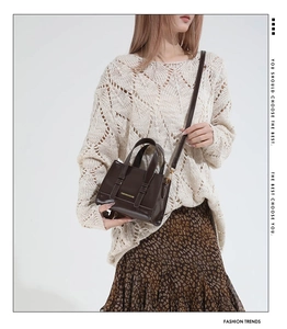 Detail view of dark coffee mini tote bag with golden lettering and metal hardware