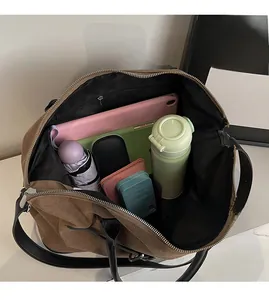 Internal view of brown canvas tote showing large capacity for tablet and daily items