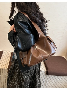 Detail view of large dark brown retro PU leather shoulder bag with buckle pockets