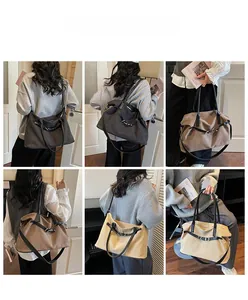Canvas tote bag in dark gray, brown and beige shown with model in indoor lifestyle setting