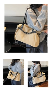 Detail of high-density canvas tote with leather straps and decorative buckles on the body