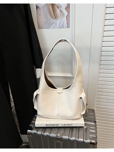 Detailed side view of ivory white hobo shoulder bag with matte finish and side pocket detail