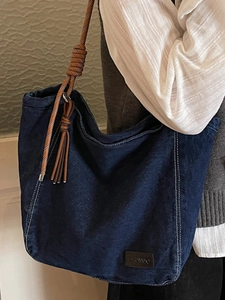 Japanese style large denim tote bag with brown woven rope straps and leather tassel