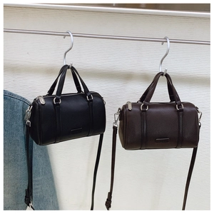Detail of Boston-style mini handbags in black and coffee leather with silver hardware