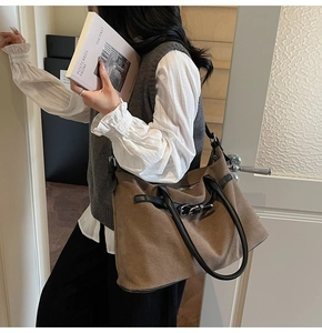 Brown frosted large tote bag with buckle detail shown in a stylish minimalist lifestyle setting