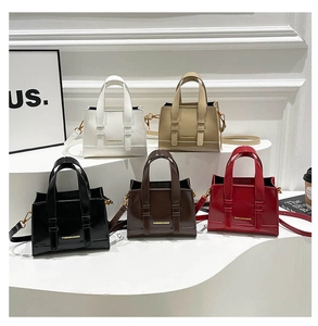 Five assorted colors of elegant PU leather tote bags with gold hardware and branding