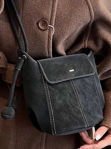 Retro black bucket shoulder bag with white contrast stitching and round ball charms