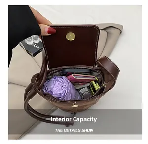 Macro view of the brown bucket bag interior showing spacious capacity for daily essentials