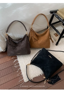 Detail of three vintage hobo bags in coffee and black suede with small coin pouches