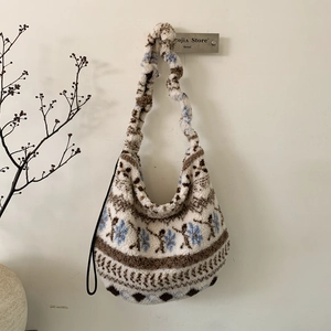 Dettaglio della borsa tote in peluche con motivi geometrici e tracolla morbida a ruches