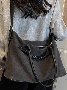 Large dark grey canvas tote bag with black leather handles and long shoulder strap