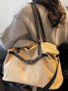 Retro canvas tote bag with black leather straps and metal rings for daily commute