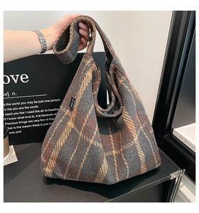 Close-up of retro plaid pattern and brand label on large wool tote shoulder bag