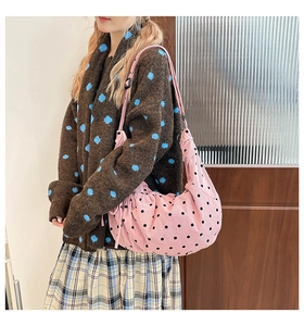 Detail of pink polka dot corduroy tote bag featuring adjustable shoulder strap and soft texture