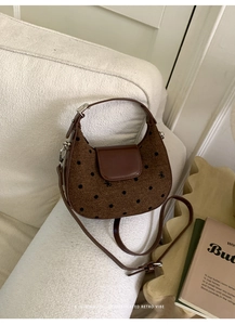 Détails de la texture du tissu marron à pois et de la broderie de nœud sur le sac