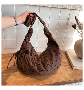 Detail of coffee brown corduroy tote bag with black polka dots and side drawstring