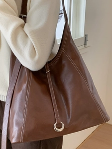 Classic dark brown leather tote bag with white contrast stitching and silver ring accent