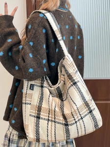 Retro striped large capacity canvas tote bag worn by a model in a minimalist home interior
