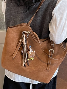 Brown suede tote bag with contrast stitching and adjustable strap plus bear charm