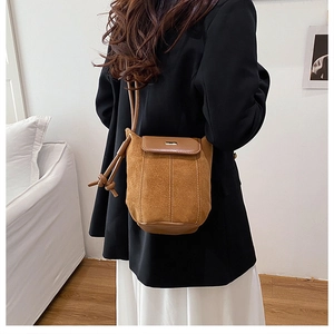 Brown suede bucket bag for women with flap closure and adjustable crossbody strap