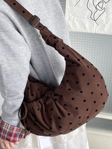 Polka dot canvas tote bag in brown with black adjustable strap and drawstring detail