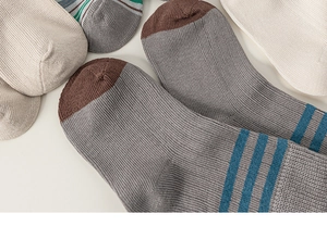 Close-up of retro cotton knit mid-calf socks showing ribbed texture and striped details