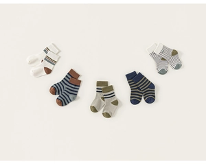 Close-up of five pairs of striped cotton mid-calf socks for children in retro earth tones