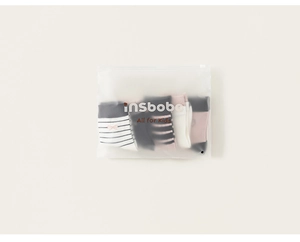 Children's socks set in matte zip bag showing striped patterns and knit textures