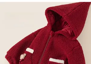 Detail of red fleece hoodie featuring a cute 3D cartoon bear and soft quilted lining