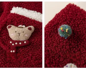 Detailed view of plush lamb wool fabric featuring a cartoon bear patch and colorful pom-poms