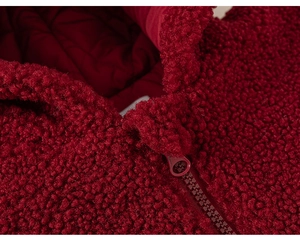 Detailed macro view of girls deep red fleece hoodie with zipper and quilted lining