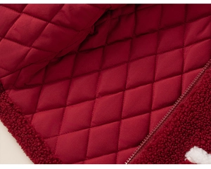 Detail view of the red sherpa fleece jacket with quilted lining and matching resin zipper