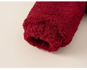 Detailed close-up of wine red sherpa fleece fabric showing soft texture and premium cuffs
