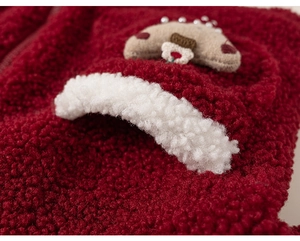 Detailed close-up of burgundy fleece hoodie pocket with cute cartoon house embroidery
