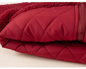 Detail of red fleece texture and quilted fabric with matching zipper on a girls set