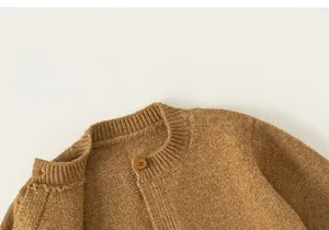 Close-up of brown knit cardigan for kids showing ribbed crewneck and button detail